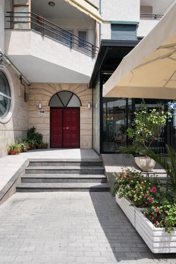 Quiet courtyard entrance with the burgundy front door of the apartment building